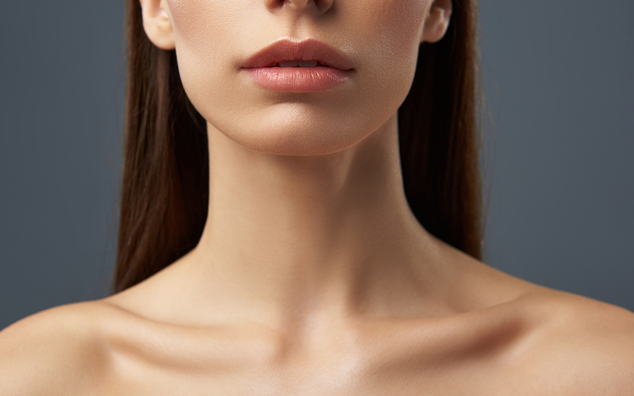 Young woman with beautiful full lips and graceful neck